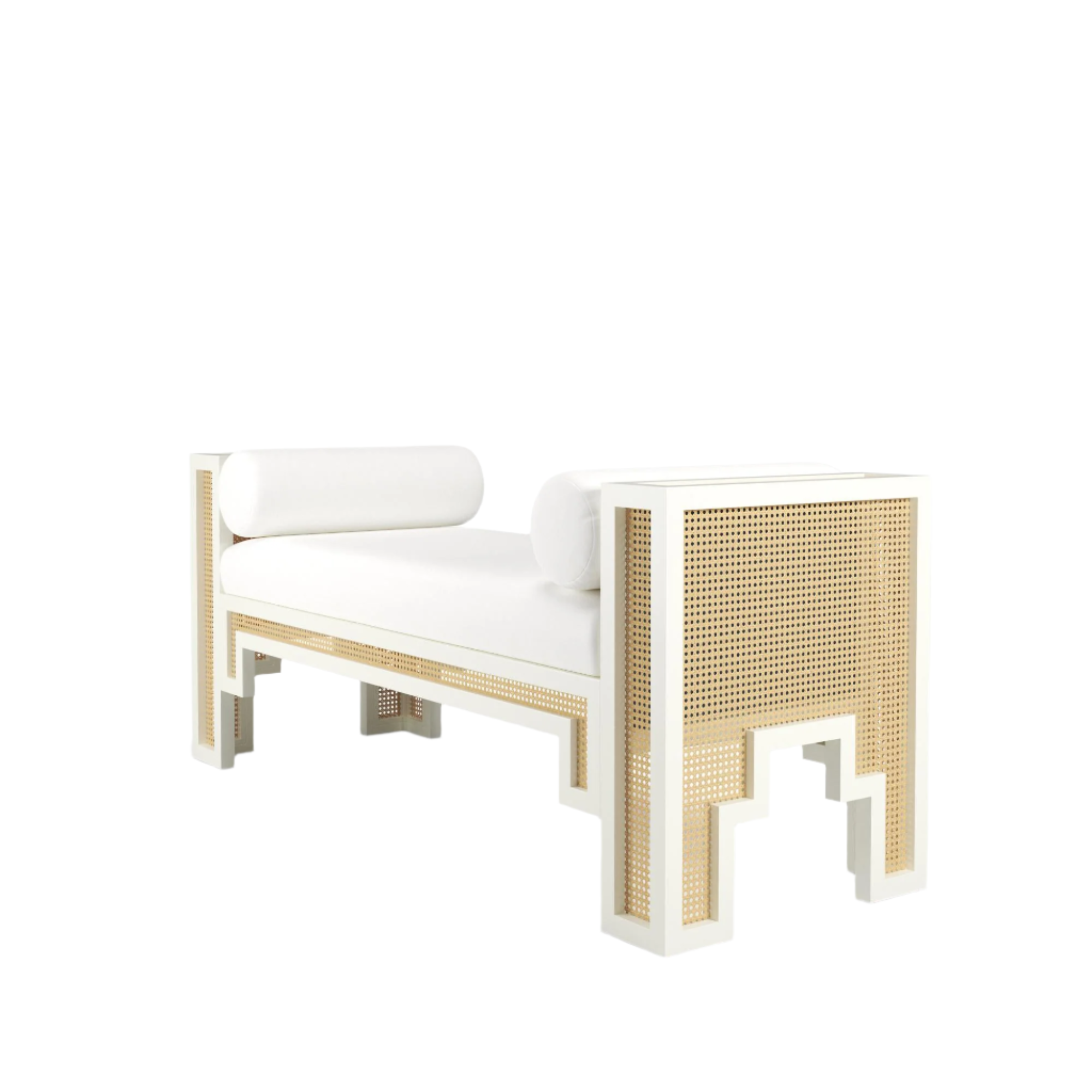 White solid wood bench with natural rattan cane panels and a white fabric upholstered seat, styled with two cylindrical bolster pillows for a boho-contemporary end-of-bed look.