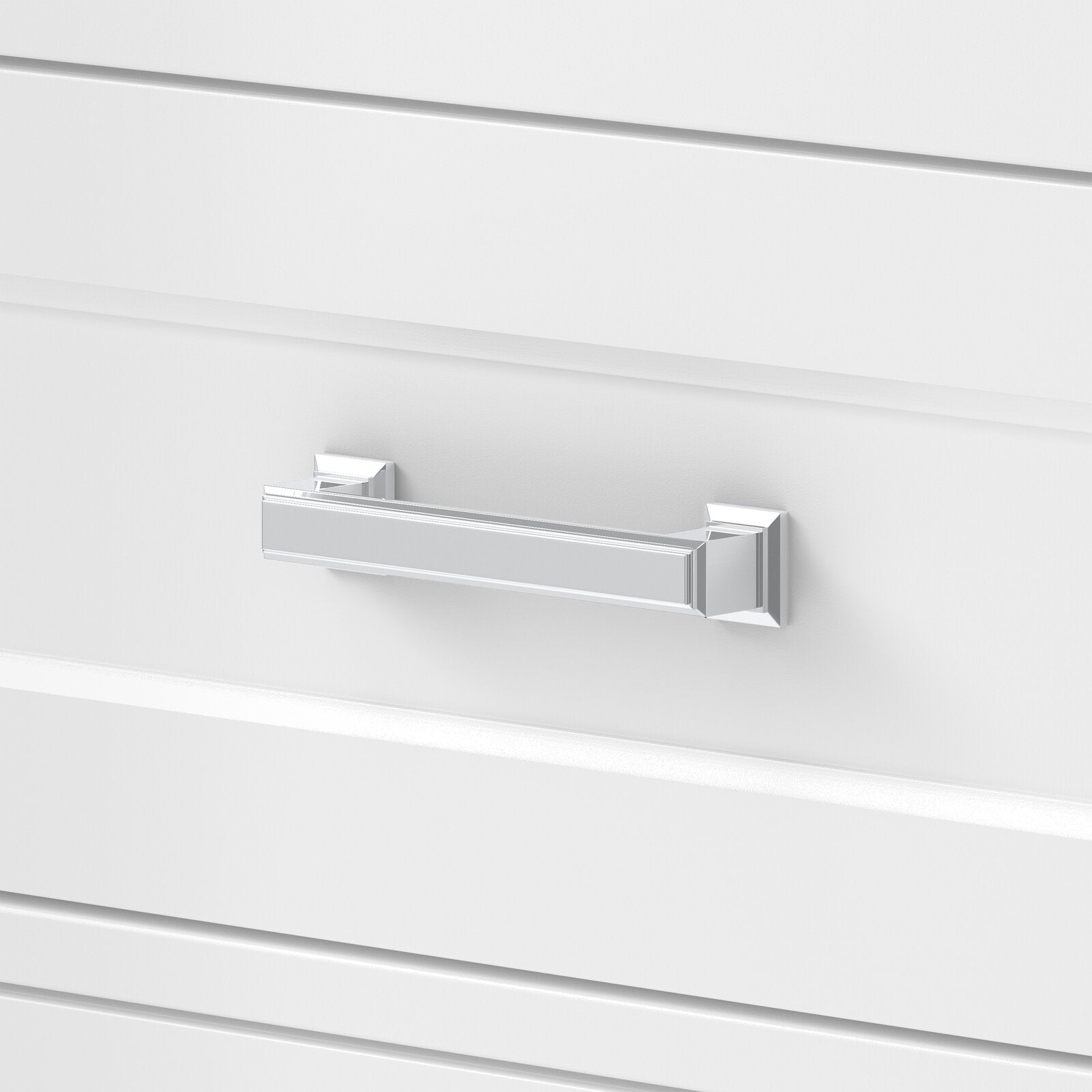 Close-up of a white solid-wood vanity drawer front with a polished chrome rectangular pull and square end caps, styled for a glam bathroom vanity.