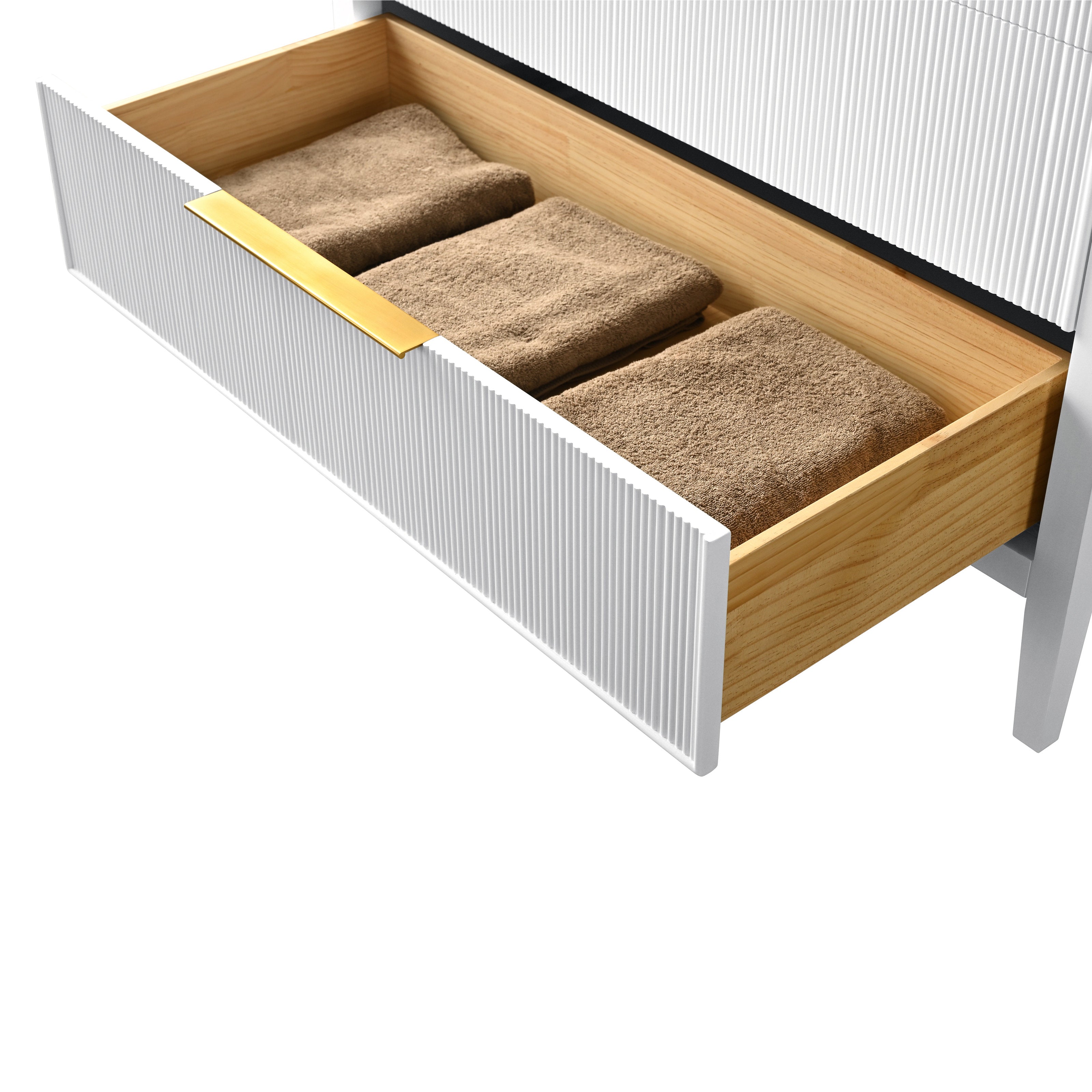 Open vanity drawer with a white fluted front and brass-tone handle revealing a natural solid wood interior holding three folded brown towels, detail of a modern single-sink bathroom vanity.