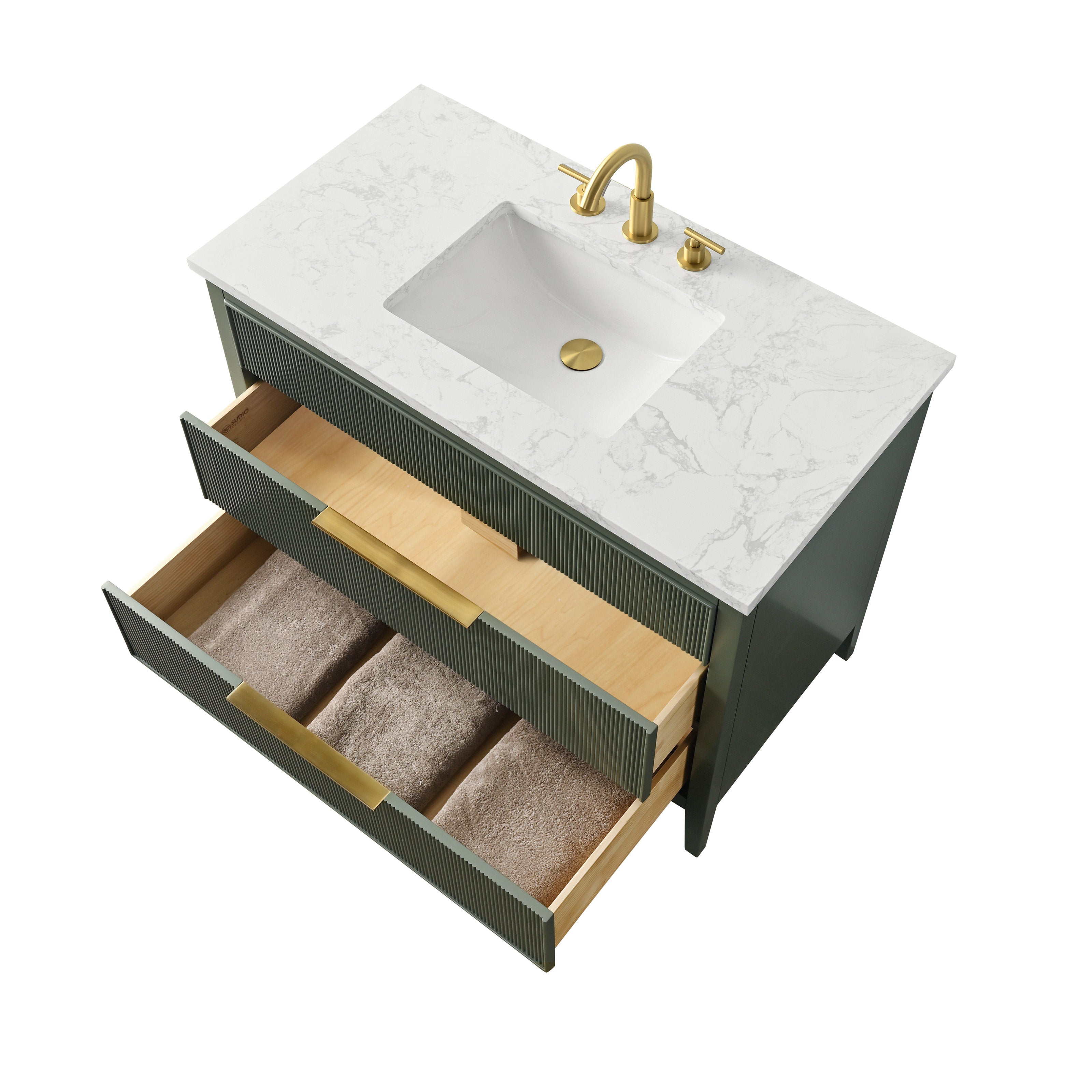 Top-down view of a modern single-sink bathroom vanity with a white stone countertop and integrated rectangular ceramic sink, solid wood fluted-front base with two open drawers showing folded towels and brass hardware.