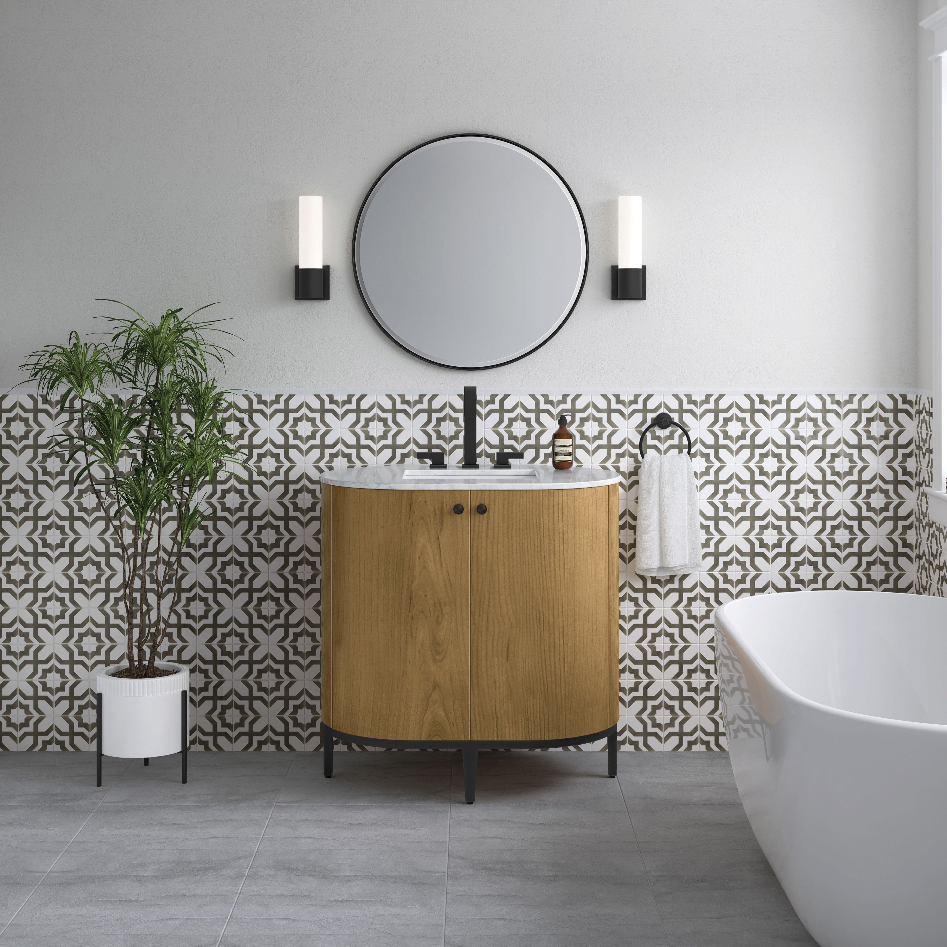 36-inch single-sink modern wood bathroom vanity with Carrara marble top, black metal legs and matte-black faucet, pictured with patterned tile half-wall, round mirror, wall sconces, potted plant and freestanding tub