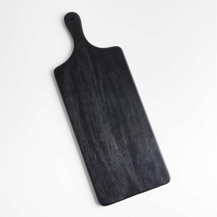 Contemporary black ash wood cutting and serving board with a short handle and hanging hole, rectangular paddle shape with visible wood grain on a white background.