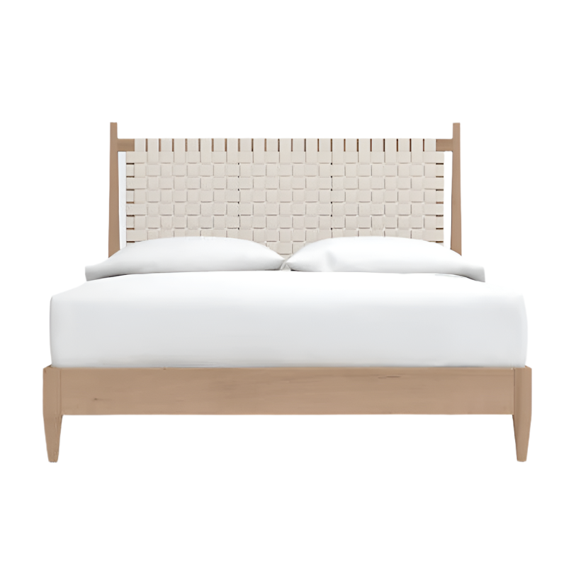 Front view of a mid-century modern teak platform bed with a cream woven rattan headboard, low teak frame and crisp white bedding.