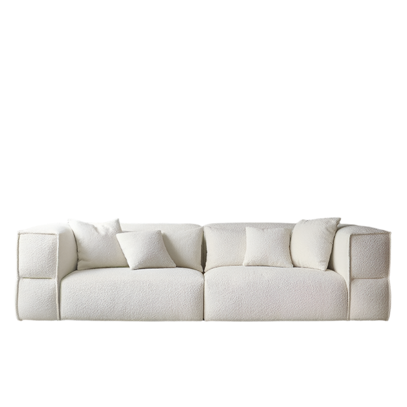 Low-profile modern sectional sofa upholstered in white boucle fabric with deep seats, wide squared arms and four matching plush cushions, shown against a plain white background.