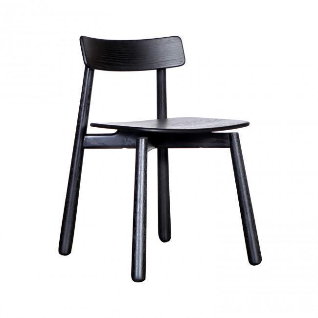 Black-stained mahogany Danish dining chair with a curved low backrest, contoured wooden seat and tapered round legs in a minimalist mid-century modern design.