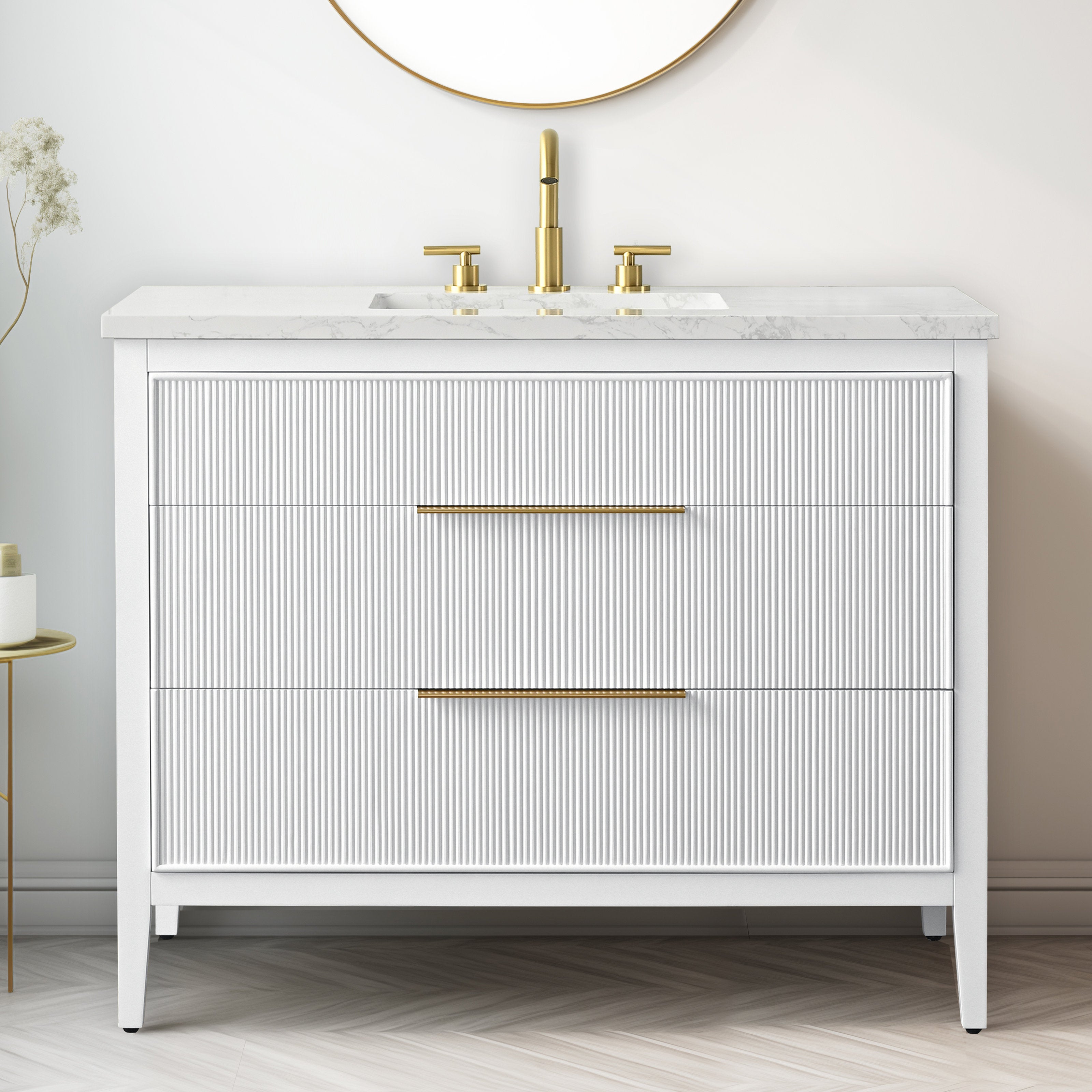Freestanding modern 42-inch single-sink bathroom vanity in white solid wood with a stone marble top, integrated rectangular ceramic basin, brass widespread faucet and slim brass handles on two ribbed-front drawers.