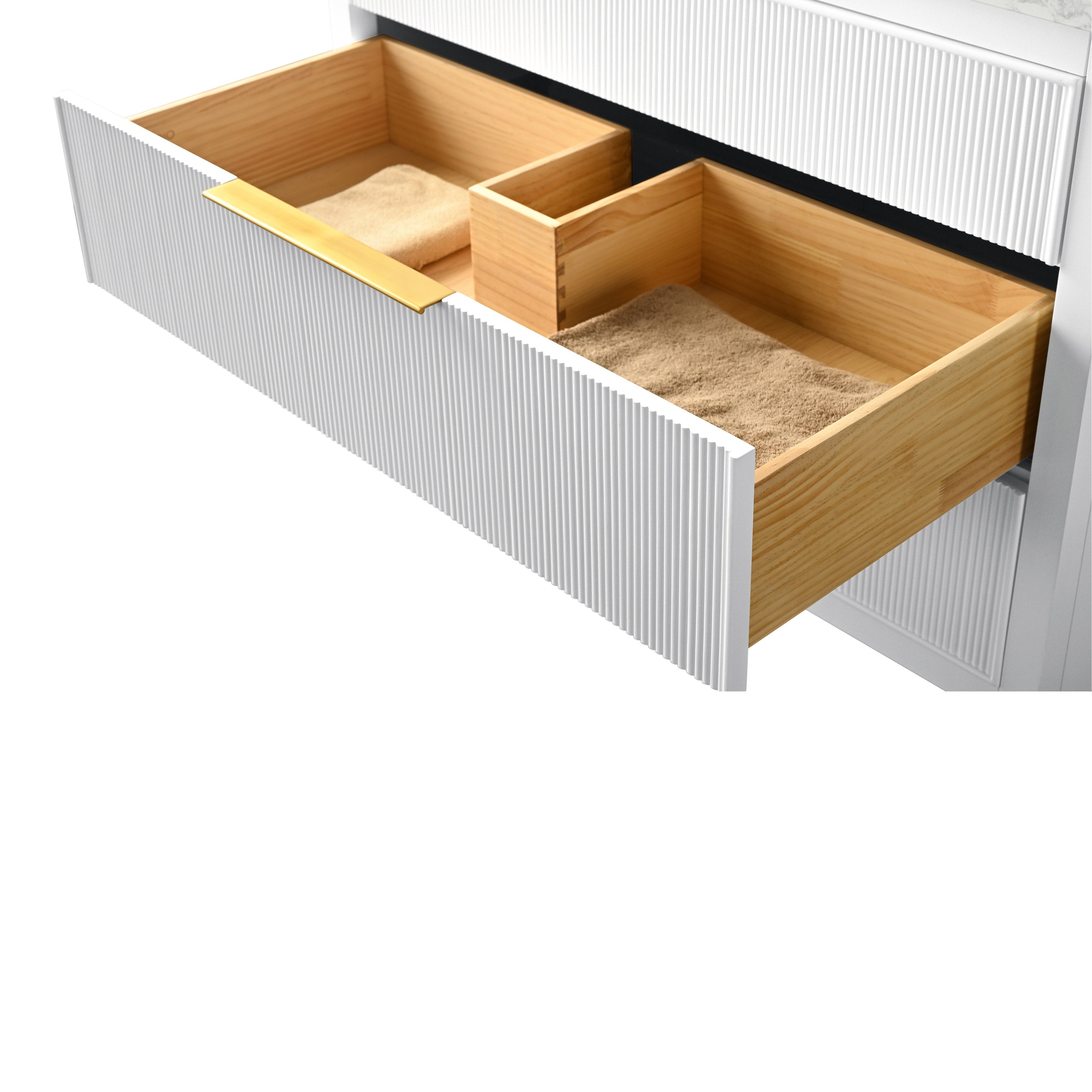 Open modern bathroom vanity drawer with fluted white front, slim gold pull and solid wood interior compartments holding folded tan towels, highlighting dovetail joinery and natural wood grain.