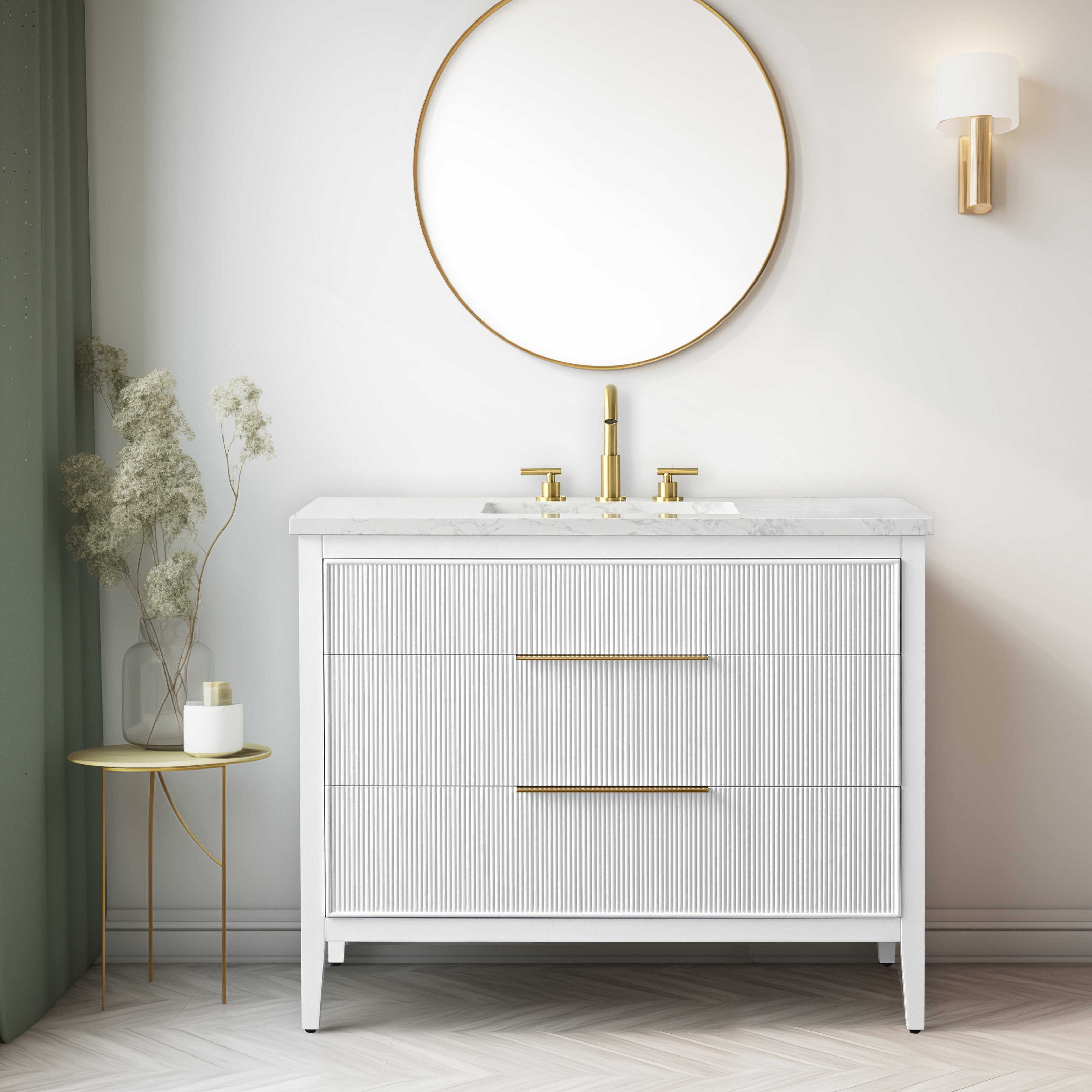 Modern freestanding 42-inch single-sink bathroom vanity with a white solid wood fluted cabinet, stone countertop and integrated sink, brass-gold faucet and long drawer pulls, shown with round gold mirror and wall sconce.