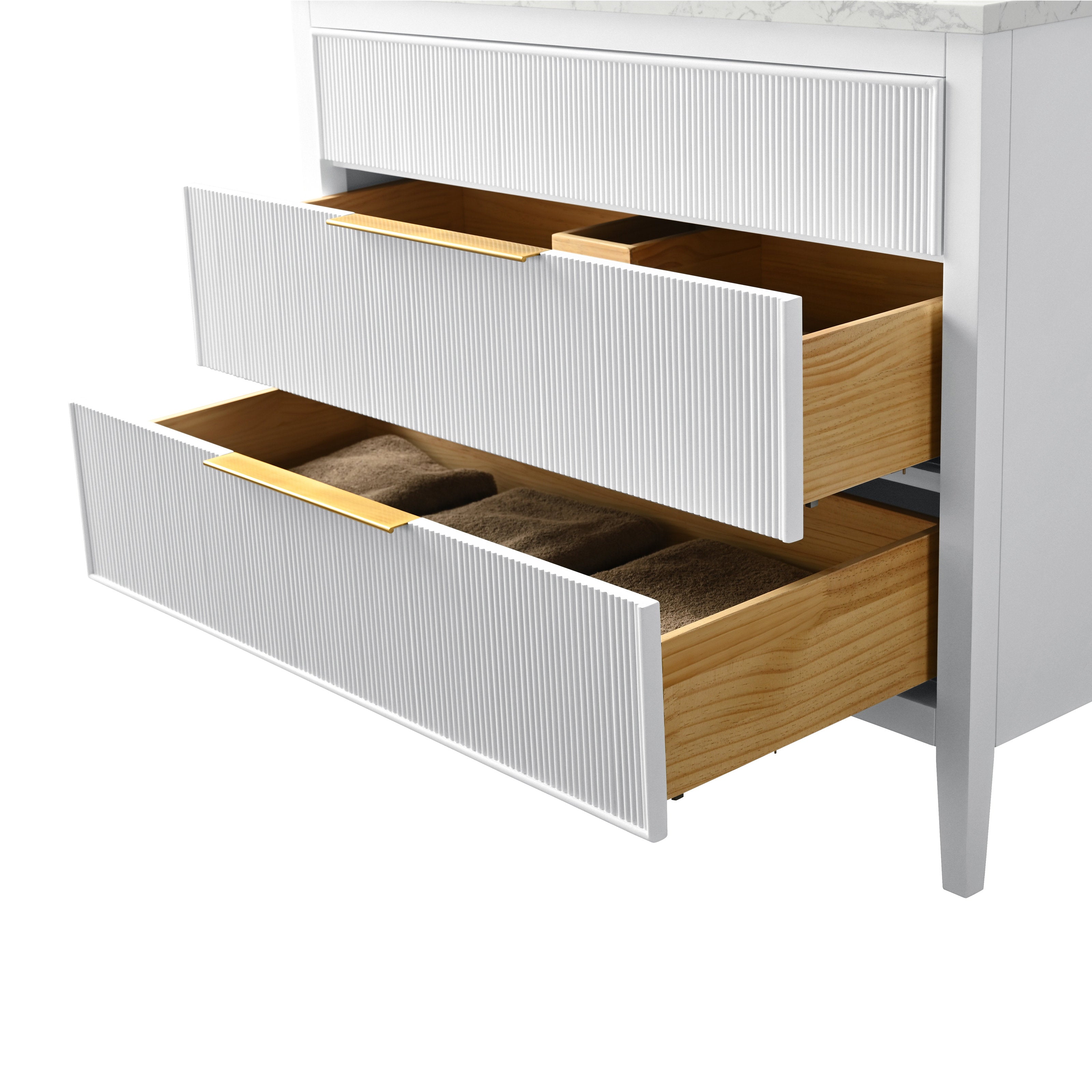 Close-up of a modern bathroom vanity with a stone top, showing two open white ribbed drawers revealing solid wood interiors, slim brass-finish handles and folded brown towels in the lower drawer.