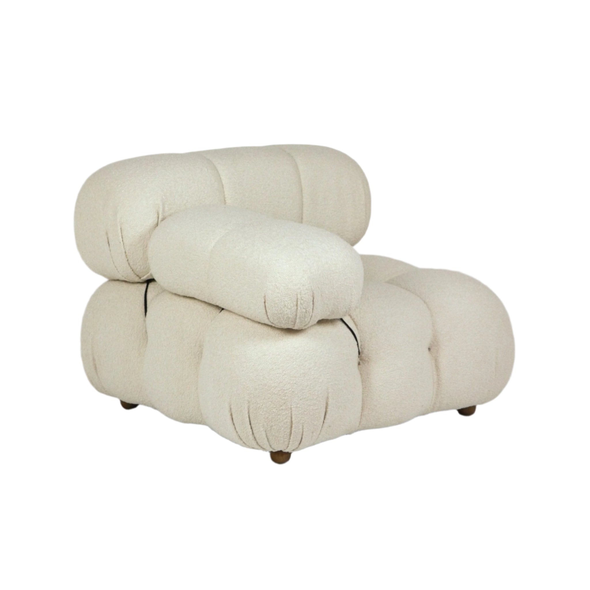 Cream boucle upholstered armless lounge chair with oversized tufted, cloud-like cushions arranged in stacked sections and short round wooden legs, shown on a white background.