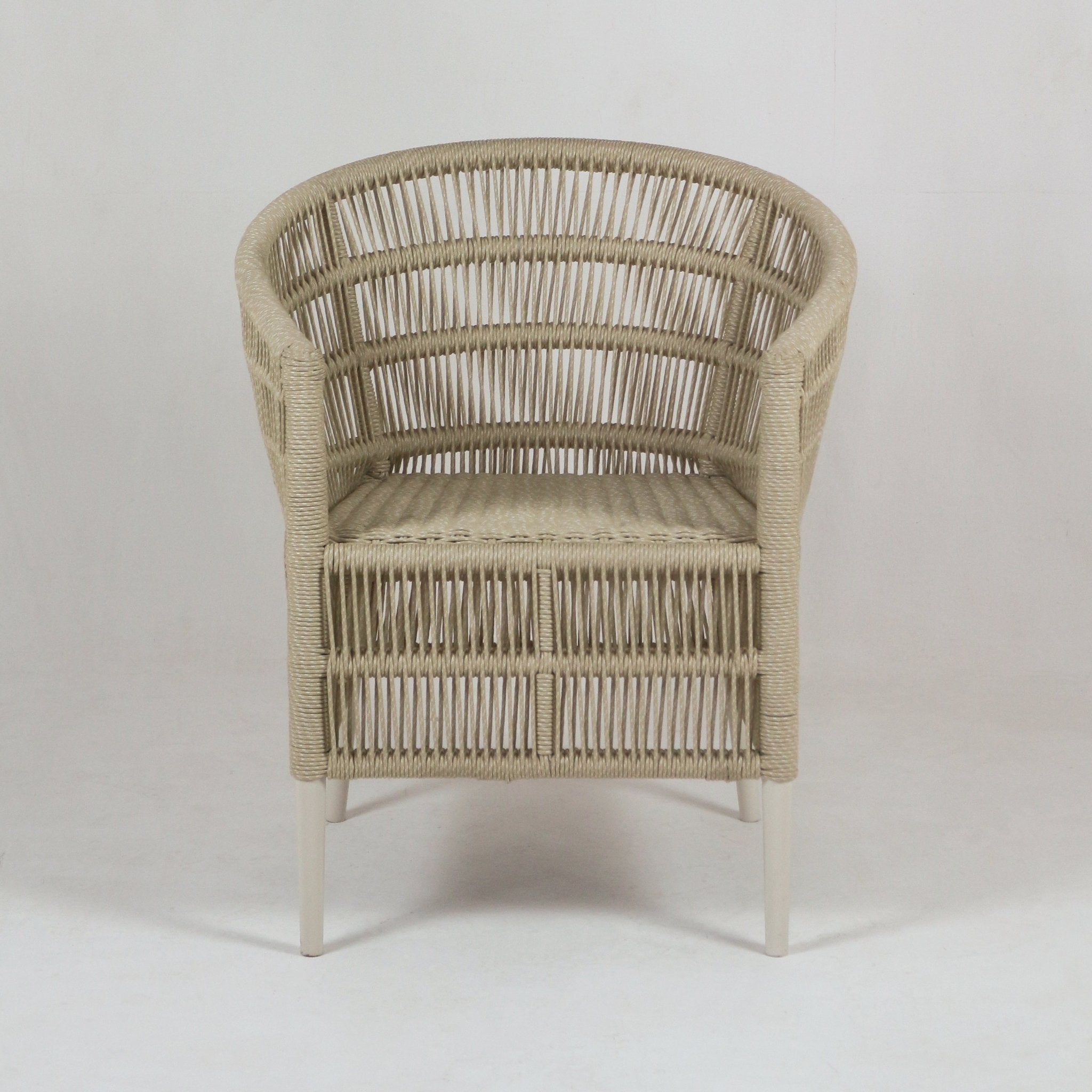 Front view of a light beige rope-woven outdoor patio chair with curved open-weave back, cushioned seat in performance outdoor fabric, and slim cream metal legs in a coastal style.