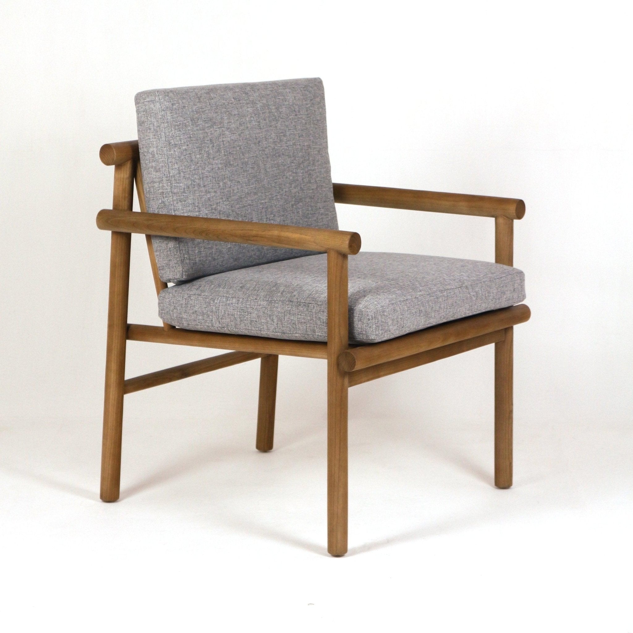 Teak-frame patio armchair with natural wood finish and light gray Sunbrella-upholstered seat and back cushions, cylindrical rail arms and slim legs in a modern coastal silhouette.