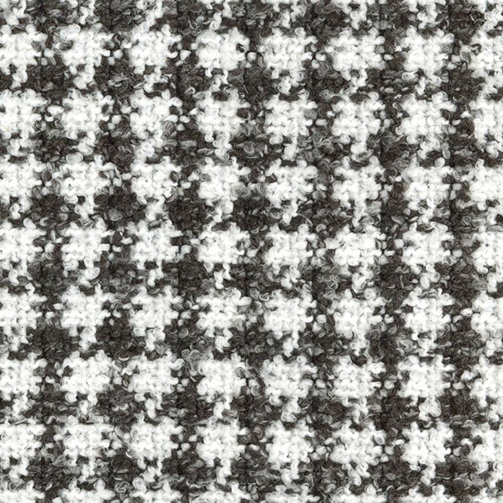 Close-up of a textured boucle upholstery fabric in white and dark gray showing a small-scale houndstooth pattern and looped yarn surface, suitable for contemporary sofa upholstery; 70% acrylic, 30% polyester.
