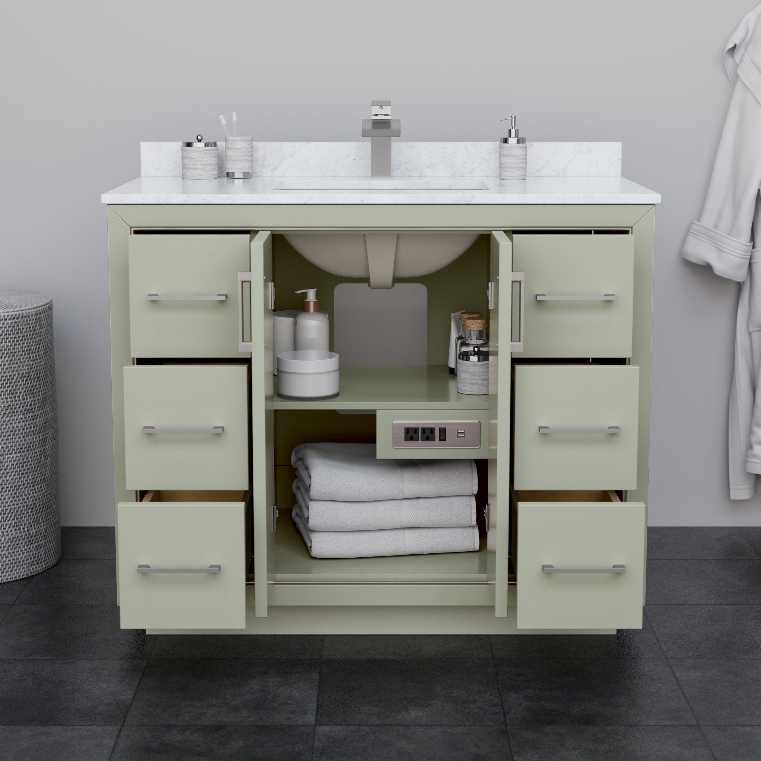 Modern solid wood bathroom vanity in a stone finish with a white stone countertop and single undermount sink, brushed-nickel faucet and handles; center doors open to show folded towels, toiletries and an integrated power outlet.